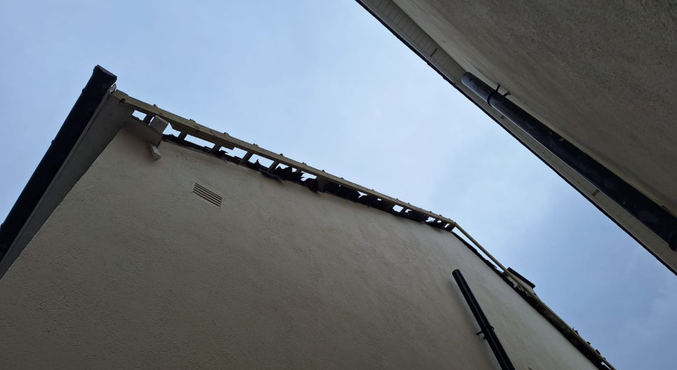 Exterior of a building with visible roof, FASCIA, SOFFITS & GUTTERS, and windows.