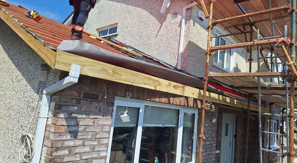 Exterior of a building with visible roof, FASCIA, SOFFITS & GUTTERS, and windows.