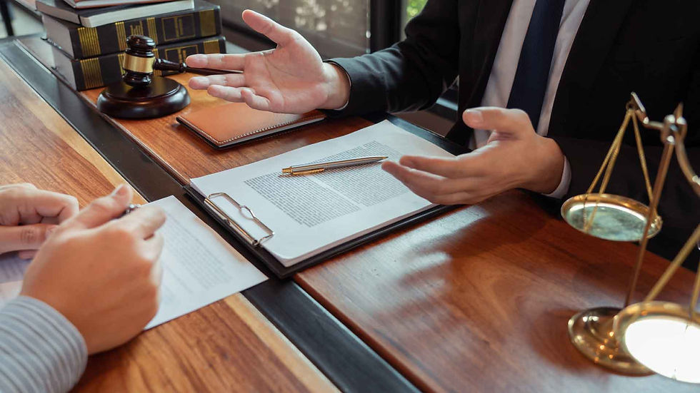 Lawyer discussing Employment Law with a client over paperwork, scales and gavel.