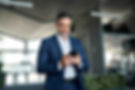 Businessman checking smartphone in office