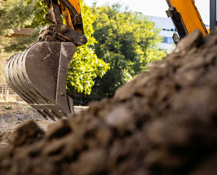 Excavator digging dirt during construction