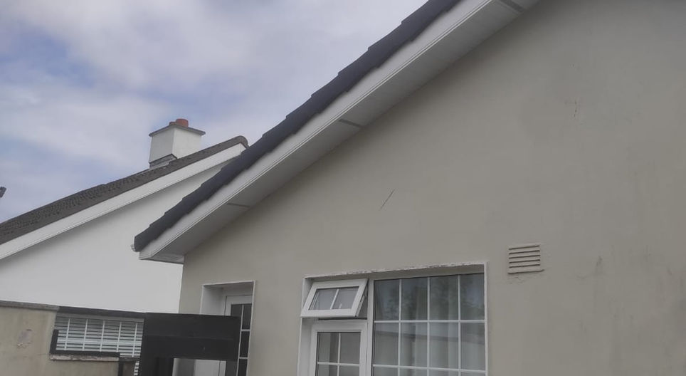 Exterior of a building with visible roof, FASCIA, SOFFITS & GUTTERS, and windows.