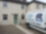 White van with A & R Windows parked in front of a house.