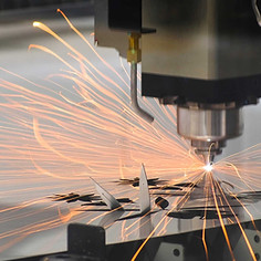 Machine cutting metal with sparks