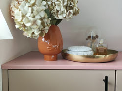 Dried hydrangeas in vase on dresser