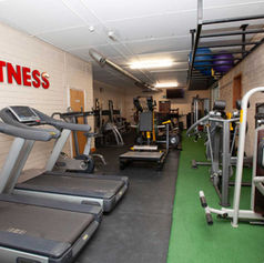 Interior of a gym with running machine and lifting machine