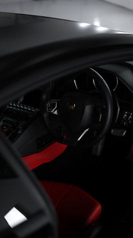 Sleek black car interior with red accents