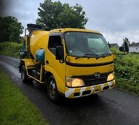 Concrete Taxi poster featuring a yellow mixer truck.
