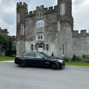 Chauffeur car outside a castle