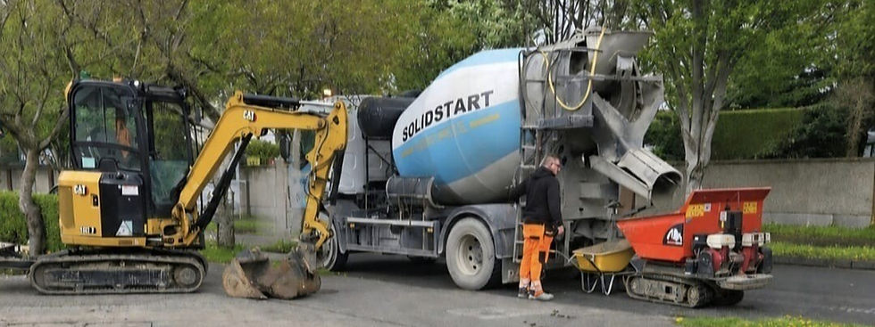 Solid Start cement truck with excavator at a construction site