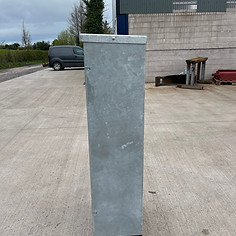 Tall galvanized metal post with black base