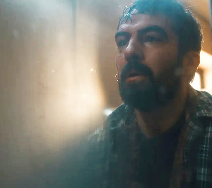 Man looking up with beard and plaid shirt, Eoghan Hand Lighting.