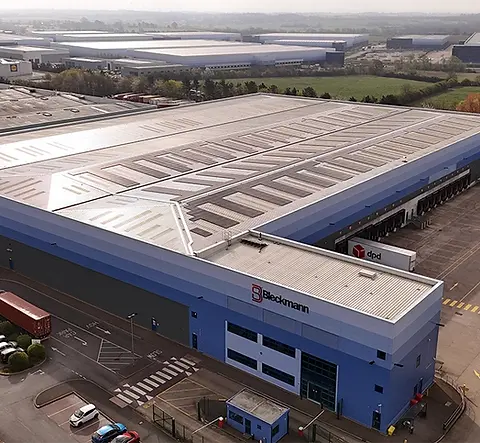 Aerial view of a large warehouse with solar panels