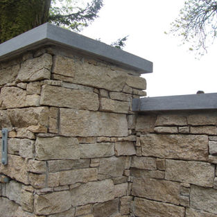 Stone pillars in garden, OConnell Stone with cap and wall structure.