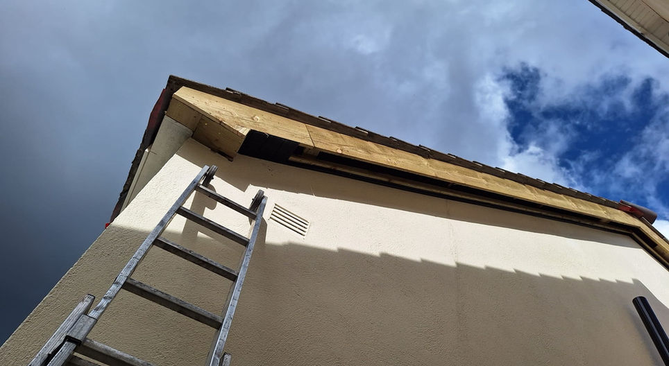 Exterior of a building with visible roof, FASCIA, SOFFITS & GUTTERS, and windows.