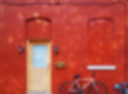 Bicycle Against a Red Wall