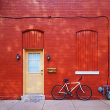 Bicycle Against a Red Wall