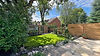 Organic natural garden in Raynes Park, South West London featuring tumbled mint sandstone paving, Kent ragstone boulders, wildlife pond, bespoke fencing, and garden room – Luxury Gardens.