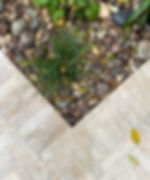 Egyptian Beige Limestone Pavers laid for a beautiful small patio with evergreen planting, and Scottish pebbles and cobbles. Contemporary garden design by luxury gardens.