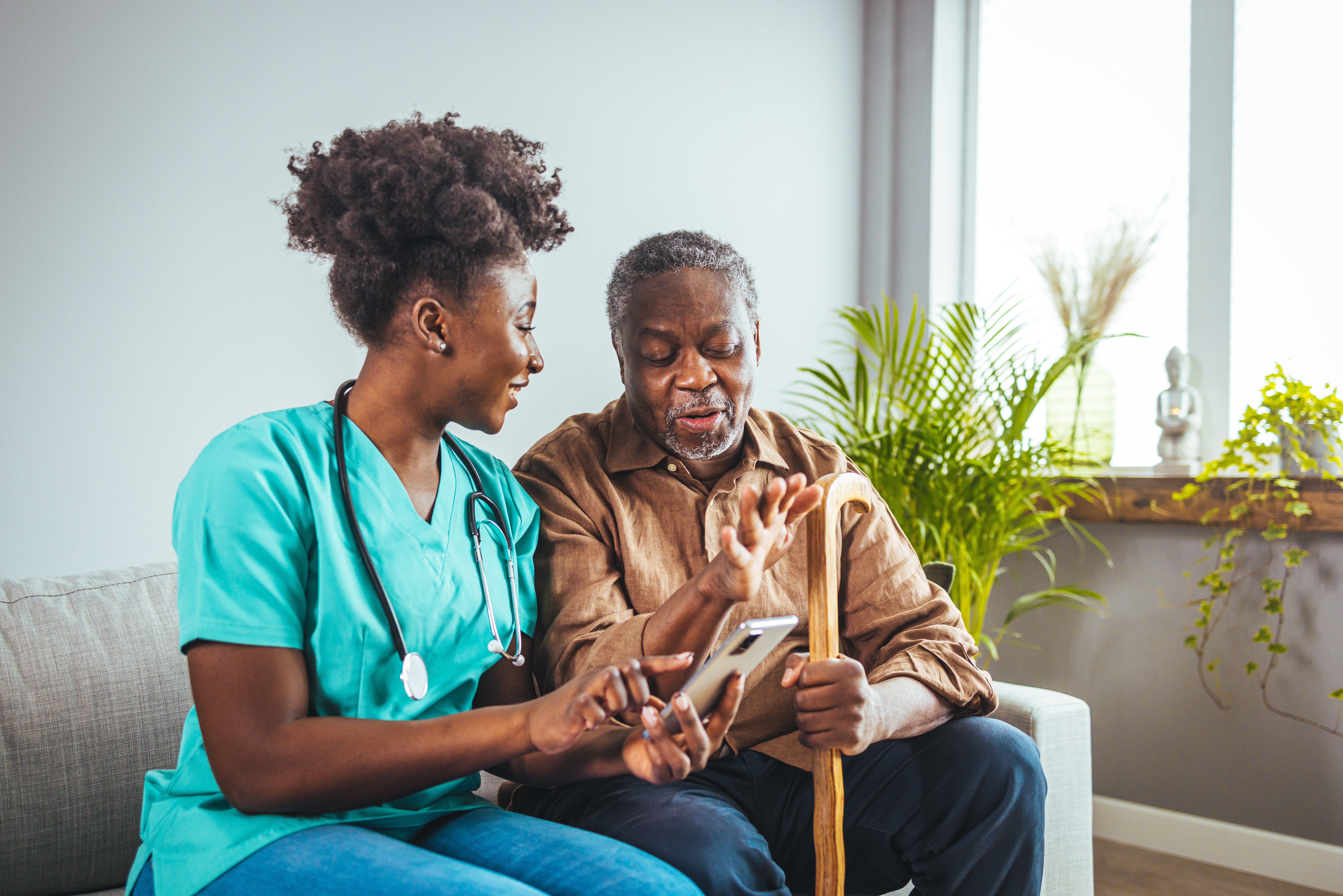 Nurse assisting an elderly resident with his medication
