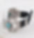 Silver turquoise watch band with black leather strap on white surface