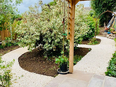 Complete garden transformation with new stone pathway, landscaping, and patio by BilnerBuilds.