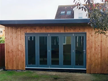 Modern timber garden room with bi-fold doors, designed and built by BilnerBuilds
