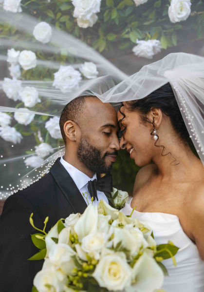 Couple underneath veil