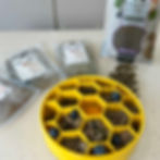 Yellow honeycomb slow feeder filled with fresh and dried dog food