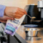 Spooning biotic bionic powder onto dog food