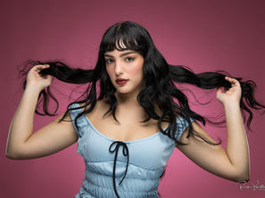a young lady posing in front of a backdrop, captured by Rick Belden Photography in Charlotte, NC