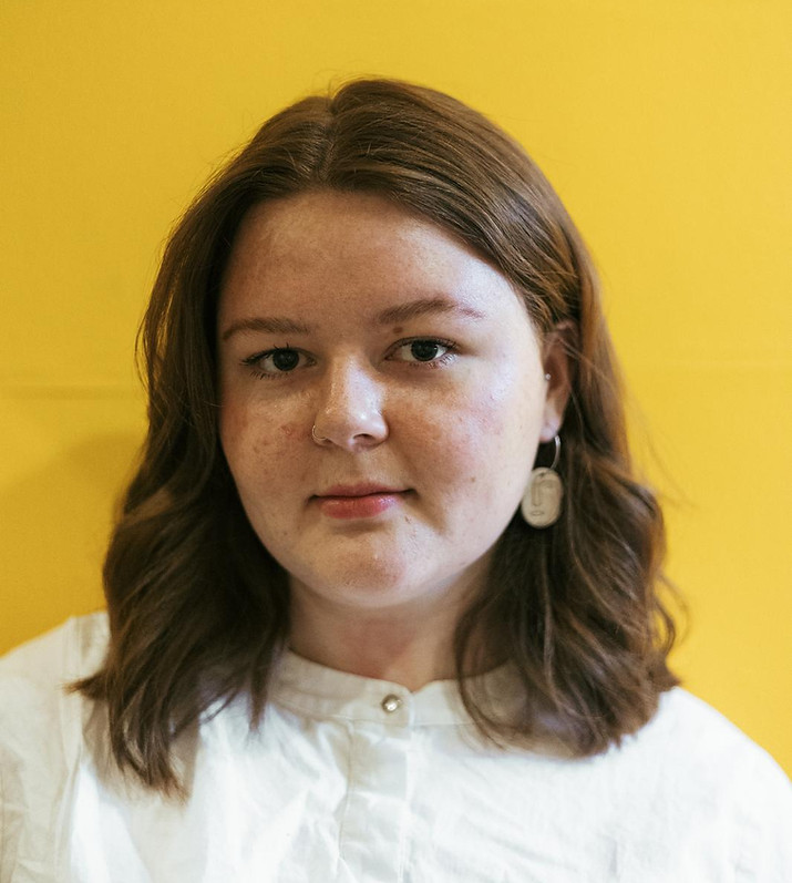 Portrait of Ellie Forrester in front of a yellow background