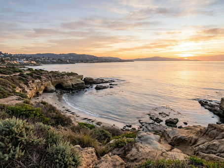 A peaceful view of La Jolla Cove in San Diego at sunrise, evoking a sense of quiet calm.