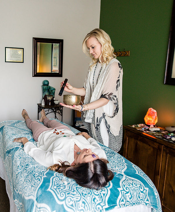 Sound healing session using a Tibetan singing bowl over the client's body to clear, cleanse and harmonize the bioenergetic field.