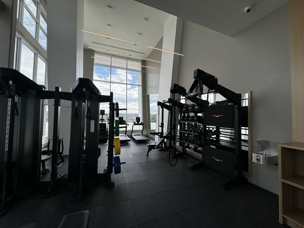 Custom frameless mirrors installed at an amenities gym, adding depth, light, and a modern finish to the workout space(2)