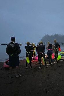 Swimmers prepare for an early morning river crossing
