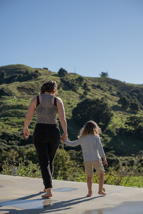 A mom and kid walk hand in hand