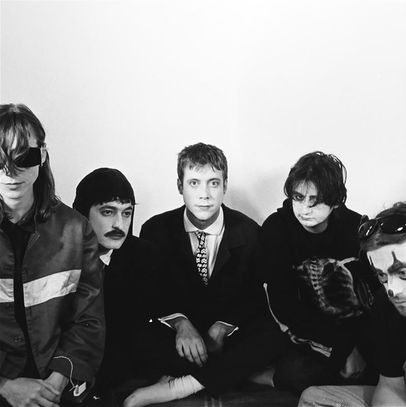 There is a certain kind of band that sounds like it learned how to speak by eavesdropping. Snatches of conversation, half-finished thoughts, the dull poetry of everyday contradiction. Sorry belong to that lineage. Their songs feel overheard rather than announced, like they’ve been pulled from the air between people who are trying, and failing, to explain themselves.
Formed in London around Asha Lorenz and Louis O’Bryen, the group circle a particular mood rather than a fixed sound. Guitars arrive scuffed and sideways, rhythms lurch rather than stride, and voices drift between detachment and something that almost resembles confession. Their early work, and especially their debut album 925, carries the uneasy charge of youth filtered through irony, where sincerity is always just slightly out of reach, like a word you can’t quite remember.
What makes Sorry compelling is their relationship with tone. They are not interested in clarity. A line might sound like a joke until it doesn’t. A melody might feel tender until it sours in your hands. There is a deliberate blurring of emotional signals, as though the band is suspicious of anything too easily understood. And yet, for all that distance, something human keeps breaking through.
Billy Elliot sits quietly within this world, almost unassuming at first. The title gestures, inevitably, toward Billy Elliot, that story of escape and aspiration, of a boy reaching for something beyond the narrow confines of his surroundings. But Sorry do not retell that narrative. They tilt it, refract it, turn it into something smaller and stranger.
The song unfolds with a kind of casual precision. Nothing announces itself as important, and yet everything feels deliberate. Lorenz’s voice carries that familiar ambiguity, hovering between boredom and revelation, as though she’s narrating events she’s not entirely convinced happened. Around her, the instrumentation shifts in subtle, uneasy ways, never quite settling into comfort.
There is a sense, listening to Billy Elliot, of expectations quietly collapsing. Where the film offers transcendence, the song seems more interested in the gap between wanting and getting, between the idea of transformation and its reality. It doesn’t mock the dream, exactly, but it doesn’t quite believe in it either. Instead, it lingers in that uncertain middle ground, where ambition becomes tangled with doubt.
And still, something persists. A flicker of longing, perhaps. A suggestion that even if the grand narrative fails, the smaller, messier version of it might still matter. Sorry have a way of letting these contradictions coexist without forcing resolution. They leave the edges rough, the meaning slightly obscured, as though to smooth it out would be a kind of dishonesty.
In the end, Billy Elliot feels less like a statement than a residue. A trace of something larger that has been worn down, reinterpreted, made intimate. It doesn’t soar. It doesn’t need to. It stays close to the ground, where most of us live, turning over the quiet, complicated business of being human and finding, in that, a strange and uneasy kind of truth.