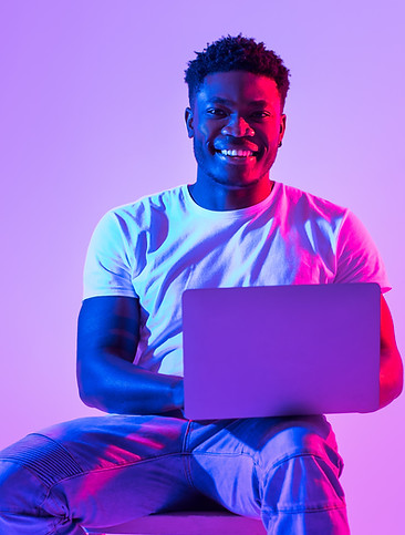 full-length-happy-millennial-black-guy-with-laptop-pc-sitting-chair-studying-working-onlin