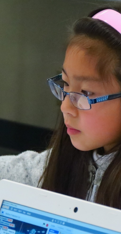 Camper focusing while coding in a Techknowhow Coding summer camp