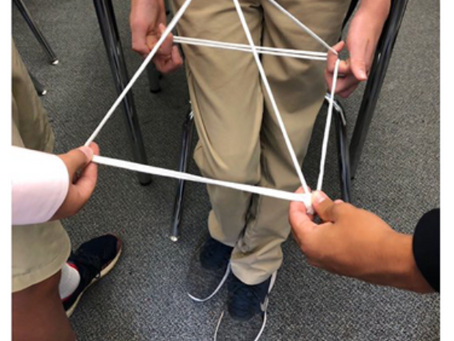 Students share their square pyramid, part of a non-curricular task they completed.