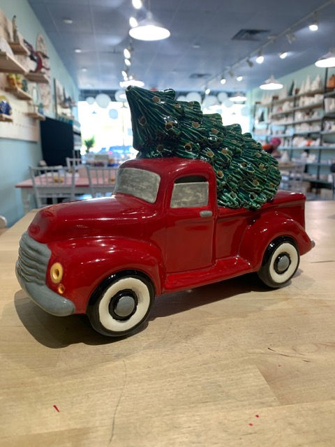 Red truck with christmas tree.