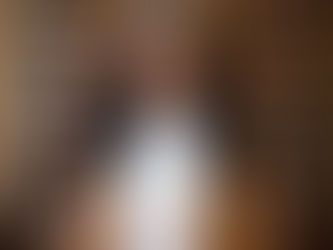 Black woman brand strategist standing in a meeting room in front of bookshelves filled with story-filled books, representing brand clarity for purpose-led founders.