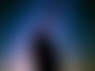 A silhouette gazes in awe at the vast expanse of a starry night sky.