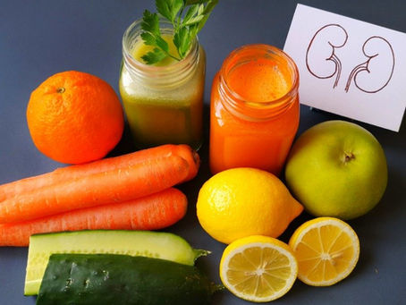 Natural Ayurvedic remedies for kidney health featuring fresh juices and vibrant produce like carrots, lemons, cucumbers, and more.