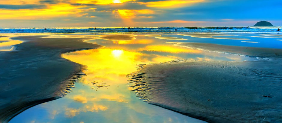 Golden rays illuminate the tranquil beach, reflecting a blessed morning's beauty.