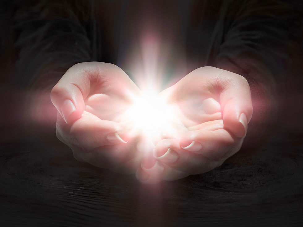 A pair of hands gently cradles a radiant light, illuminating the surrounding darkness.