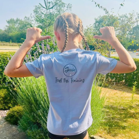 Back of the personalised gymnastics t-shirt worn by young gymnast in garden