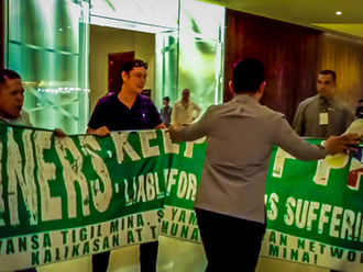 ACTIVISTS STORM MINING CONFERENCE