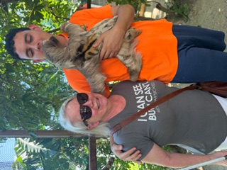Julie with a sloth and a travel buddy